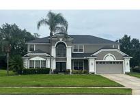 Stately two-story home with manicured lawn and mature landscaping at 633 Grand Cypress Pt, Sanford, FL 32771