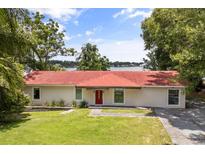 Charming home with a red-tile roof and a beautiful waterfront view at 6665 Lake Cane Dr, Orlando, FL 32819