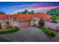 Charming one-story home featuring a red tile roof, spacious driveway, and well-maintained landscaping at 903 Santa Anna Ln, Lady Lake, FL 32159