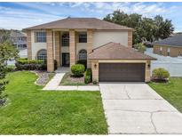 Stunning two-story home with a well-manicured lawn and a two-car garage at 1109 Needlewood Loop, Oviedo, FL 32765