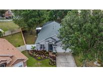 Charming single-Gathering home featuring a well-manicured lawn and inviting curb appeal at 1130 Woodsong Way, Clermont, FL 34714