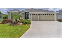 Charming single-story home with a well-manicured lawn, lovely landscaping, and a spacious driveway at 4346 Pezzullo Cir, The Villages, FL 32163