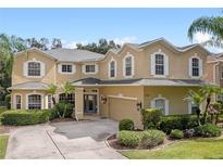 Beautiful two-story home with lush landscaping, manicured lawn, and a well-maintained driveway at 5144 Rishley Run Way, Mount Dora, FL 32757