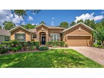 Charming single-story home with manicured lawn, stone accents, and inviting curb appeal at 1556 Blue Grass Blvd, Deland, FL 32724