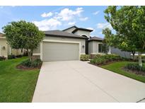 Charming single-story home with a well-manicured lawn and attached two-car garage at 2400 Pawtucket Pass, Mount Dora, FL 32757