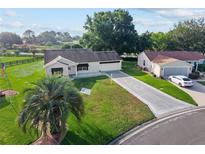 Charming single-story home featuring a well-manicured lawn and decorative driveway at 2557 Privada Dr, The Villages, FL 32162