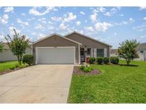 Charming single-story home with well-maintained lawn and an attached two-car garage at 5068 Ne 121St Ave, Oxford, FL 34484