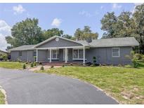 Charming single-story home with a well-manicured front yard and a welcoming covered entrance at 604 Ponderosa Dr, St Cloud, FL 34769