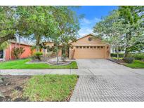 Charming single-Gathering home with a two car garage, brick paver driveway and meticulous landscaping at 645 Highlands Hammock Dr, Kissimmee, FL 34759