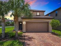 Beautiful two-story home with a brick driveway and well-maintained landscaping at 8800 Corcovado Dr, Kissimmee, FL 34747