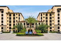 Beautiful resort-style exterior view of building featuring manicured landscaping and palm trees at 16300 County Road 455 # 202, Montverde, FL 34756