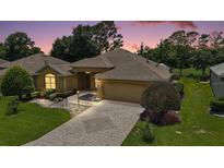 Charming single-Gathering home with paver driveway, mature landscaping, and attached two-car garage at 16862 Se 80Th Bellavista Cir, The Villages, FL 32162