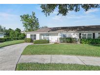 Charming single-story home featuring a well-maintained lawn and inviting curb appeal at 1726 Tropical Ct, Tavares, FL 32778