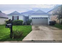 Charming single-Gathering home with a well-manicured lawn and a two-car garage at 222 Bacopa Pass, Davenport, FL 33897