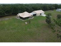 Spacious country home featuring a large lawn and detached garage/workshop at 3147 Rambler Ave, St Cloud, FL 34772