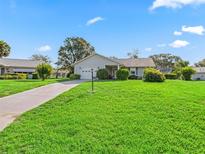 Charming single-story home with a well-manicured lawn and attached one car garage at 512 Galloway Ct, Leesburg, FL 34788