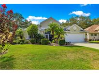 Charming single-Gathering home boasts a well-manicured lawn and tropical landscaping at 8045 Waterbury Way, Mount Dora, FL 32757