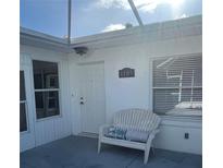 Charming front porch with a cozy bench, perfect for enjoying the neighborhood view at 1105 Hazelnut Dr, Leesburg, FL 34748