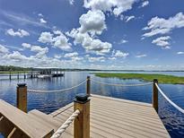 Beautiful view from the waterfront dock with covered boat lift and access to the serene lake at 11401 Cypress Dr, Clermont, FL 34711