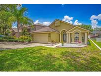 Charming single-Gathering home with well-manicured lawn, inviting curb appeal, and a two-car garage in a sunny setting at 1906 Chathamoor Dr, Orlando, FL 32835