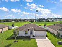 Charming single-story home with a well-manicured lawn and attached two-car garage in a Gathering-friendly community at 1940 Piedmont Ct, Mascotte, FL 34753