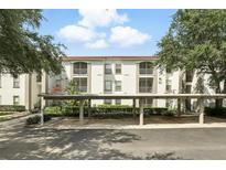 Exterior angle shot showcasing a condo building with covered parking and balconies at 2639 Maitland Crossing Way # 102, Orlando, FL 32810