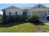 Charming single-story home featuring a well-manicured lawn and attached two car garage at 3260 Casa Del Rey Ave, Kissimmee, FL 34746