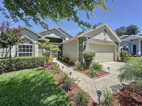 Charming single Gathering home featuring a well-maintained lawn and inviting curb appeal at 3716 Eversholt St, Clermont, FL 34711