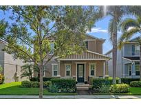 Charming two-story home featuring manicured landscaping, covered porch, and inviting entrance at 7901 Iceland Gull St, Winter Garden, FL 34787