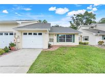 Charming single-story home with a well-maintained front lawn, attached garage, and inviting curb appeal at 1467 Disston Ave, Clermont, FL 34711