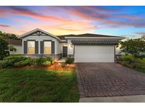 Charming one-story home with a brick driveway, manicured lawn, and professionally designed landscaping at 4701 Nw 51St Terrace Rd, Ocala, FL 34482