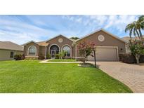 Charming home featuring manicured lawn, paver driveway, and inviting curb appeal at 4826 Sable Ridge Ct, Leesburg, FL 34748