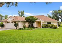 Inviting single-story home with well-manicured lawn and mature landscaping, creating curb appeal at 5729 Bible Camp Rd, Groveland, FL 34736