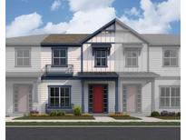 Charming townhome showcases a classic design with a red front door, complemented by stylish blue trim and a cozy front porch at 6527 Trailblaze Bnd, St Cloud, FL 34771
