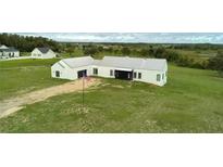 Expansive modern home with a metal roof surrounded by an open green lawn at 10711 County Road 561, Clermont, FL 34711