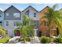 Charming multi-colored townhomes featuring modern architecture and lush palm trees at 1603 Woodward St # 18, Orlando, FL 32803