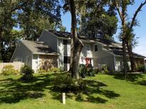 Charming two-story home featuring stone accents and lush landscaping at 2108 Dogwood Cir, Mount Dora, FL 32757