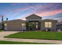 Charming single-story home with a well-maintained lawn and a two-car garage at 27328 Pine Straw Rd, Leesburg, FL 34748