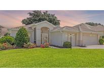 Charming single Gathering home with an arched entry and well manicured landscaping at 4909 Kelso St, Leesburg, FL 34748