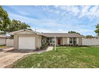 Charming single-story home featuring a well-manicured lawn, a light post and an attached one car garage at 1491 Providence Blvd, Deltona, FL 32725