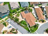 Stunning aerial view of home showing the beautiful landscaping, well-maintained lawn, and private pool at 1509 Trenton Ln, The Villages, FL 32162