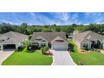 Charming single-story home featuring a well-manicured lawn, tasteful landscaping, and a two-car garage at 2369 Unity Ter, The Villages, FL 32162