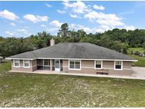 Charming home featuring a spacious backyard, screened porch and classic architecture at 37007 Forestdel Dr, Eustis, FL 32736