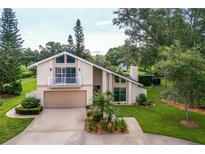 Charming two-story home with a balcony, two-car garage and landscaped yard at 37138 Lake Yale Pl, Grand Island, FL 32735