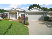 Charming single-story home with a well-manicured lawn and an attached two-car garage at 4904 Long Meadow Dr, Leesburg, FL 34748