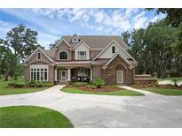 Charming two-story home with landscaped yard and inviting front entrance on a sunny day at 1325 Otters View Ct, Fruitland Park, FL 34731