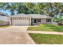 Charming single-story home with a well-manicured lawn and two-car garage at 1511 W Magnolia St, Clermont, FL 34711