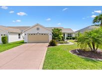 Charming single Gathering home with well manicured landscaping and an attached two car garage at 2017 Palo Alto Ave, The Villages, FL 32159