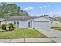Charming one-story home with a well-maintained lawn and an attached garage at 2743 Nattie Ct, Orlando, FL 32826