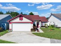 Charming single-story home featuring a well-maintained lawn and attached two-car garage at 3016 Bloomsbury Dr, Kissimmee, FL 34747